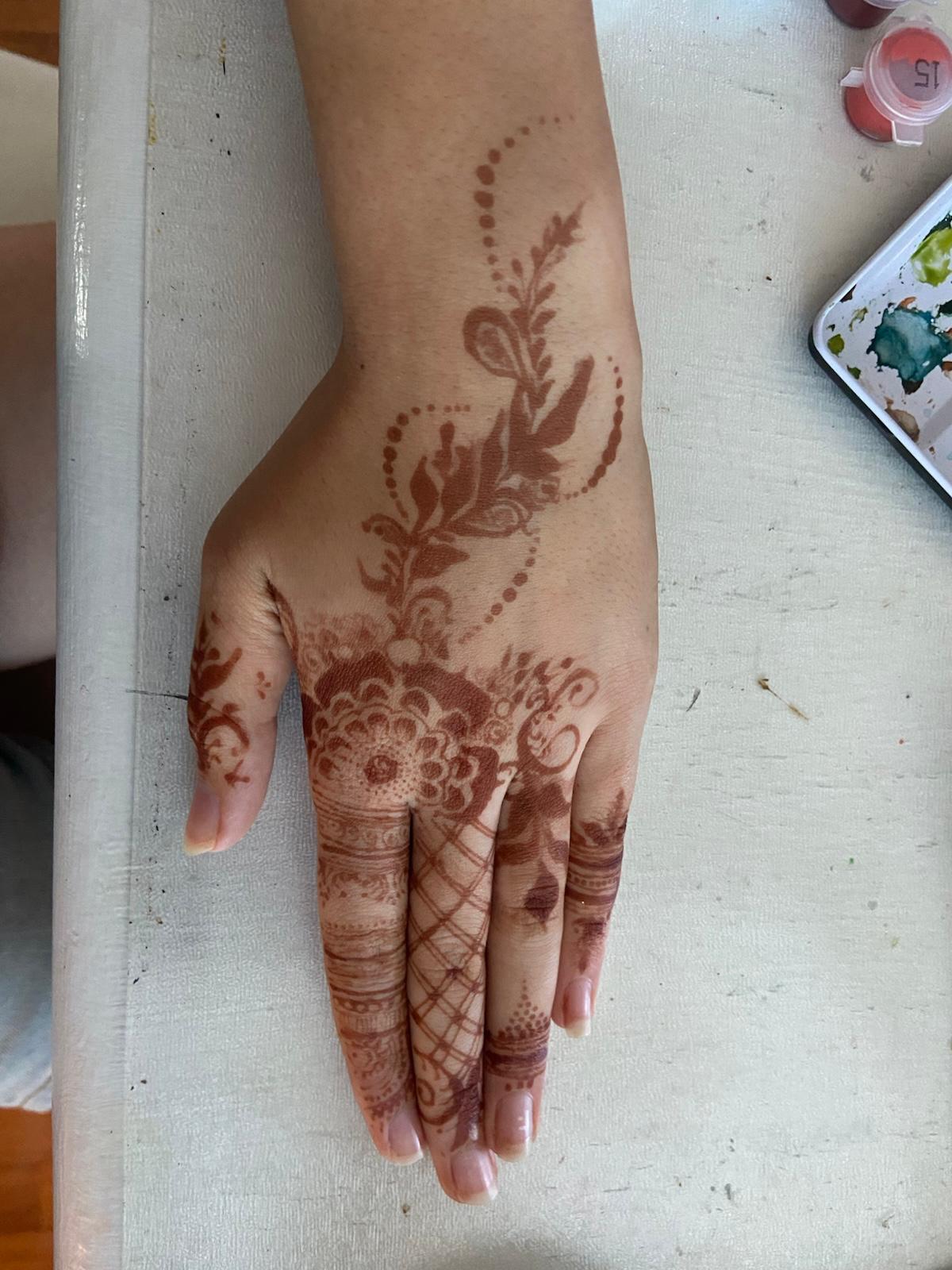 Trailing vine and leaf henna on the back of the hand