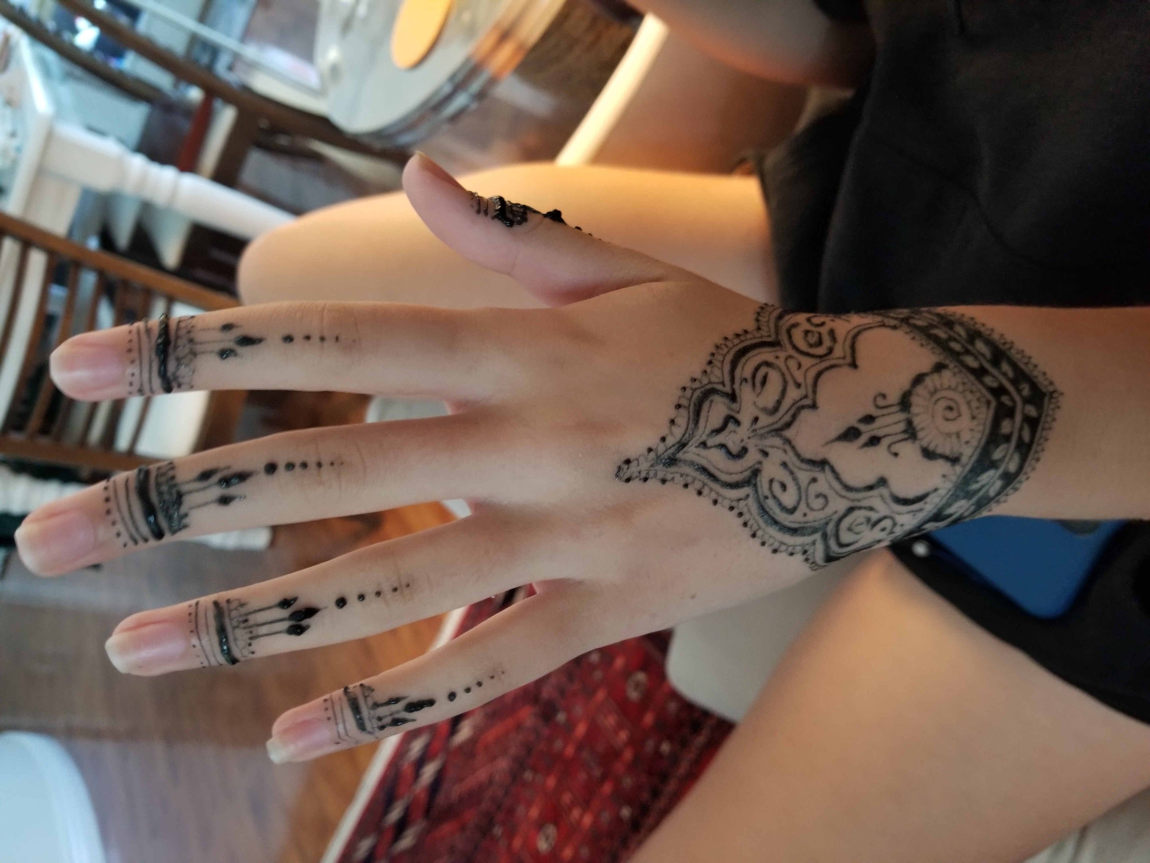 Mandala on the back of the hand with finger jewellery